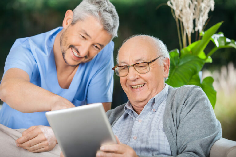 SoCo Village | Senior and caregiver looking at a tablet