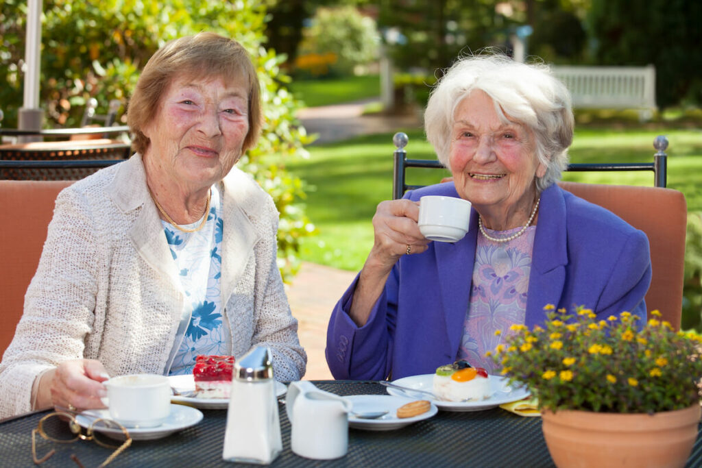 SoCo Village | Happy senior women socializing and having tea