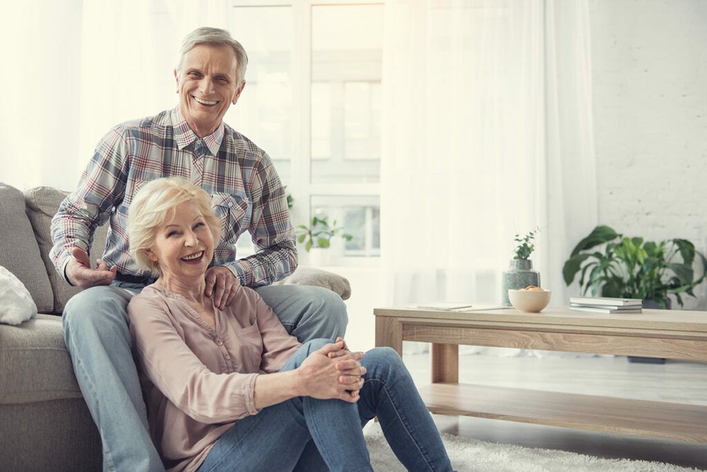 SoCo Village | Happy senior couple sitting in apartment