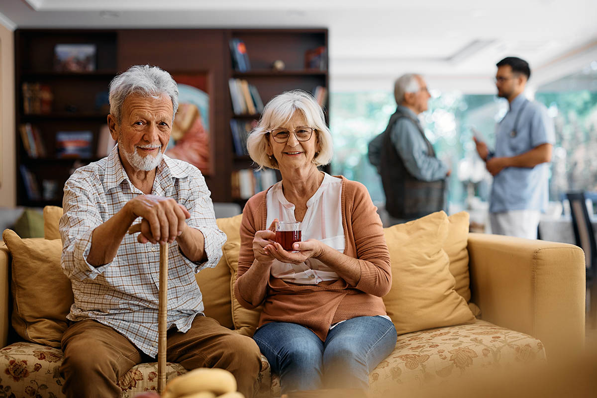 SoCo Village | Happy senior couple at residential care home looking at camera.